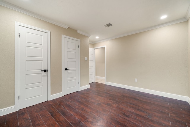 spare room featuring dark hardwood / wood-style floors and ornamental molding