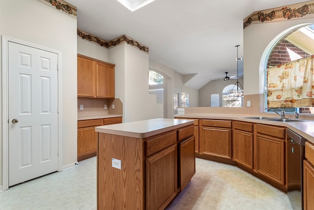 kitchen with kitchen peninsula, ceiling fan, sink, dishwasher, and a kitchen island