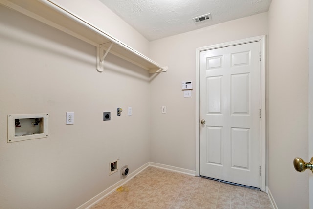 laundry area with washer hookup, electric dryer hookup, and a textured ceiling