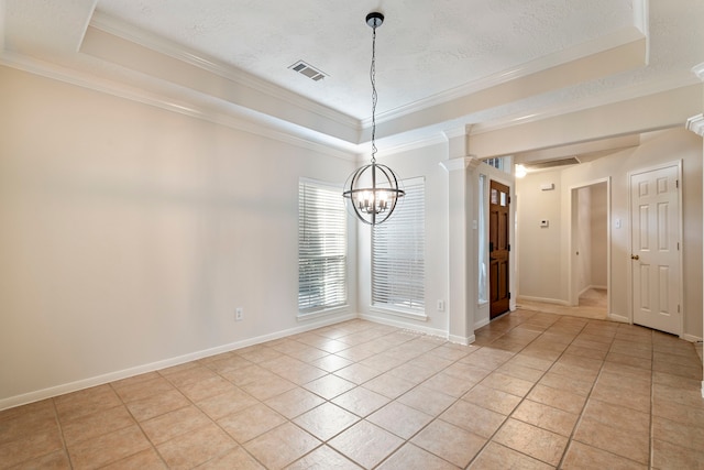 tiled spare room with a tray ceiling, ornate columns, crown molding, and a textured ceiling