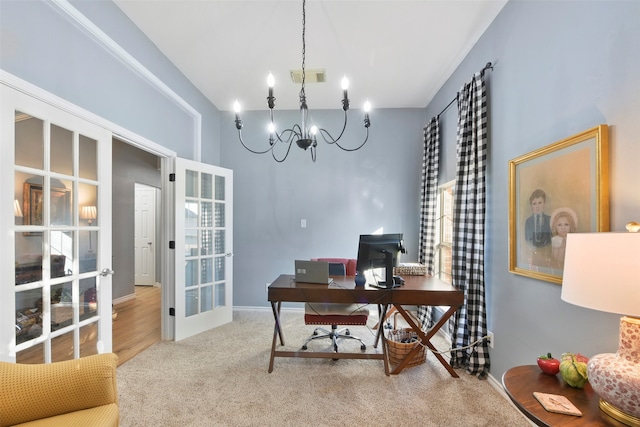 home office with hardwood / wood-style flooring and an inviting chandelier