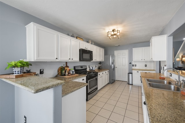 kitchen featuring kitchen peninsula, sink, white cabinets, and appliances with stainless steel finishes