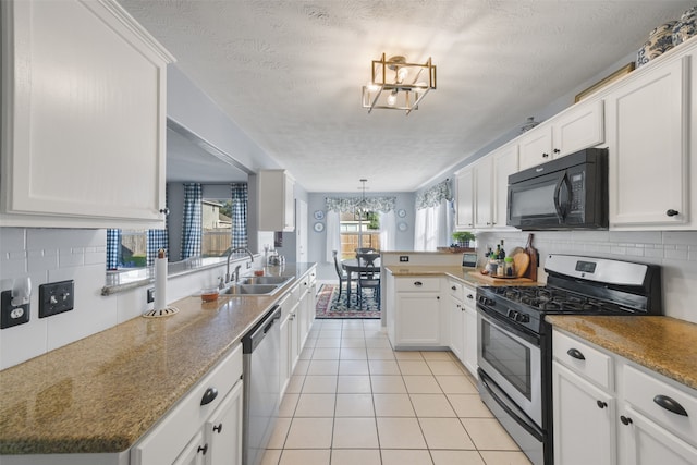 kitchen with white cabinetry, sink, a textured ceiling, and appliances with stainless steel finishes