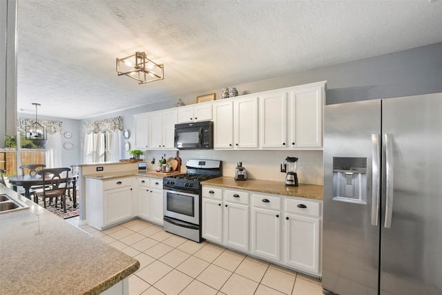 kitchen with pendant lighting, a textured ceiling, a notable chandelier, white cabinetry, and stainless steel appliances