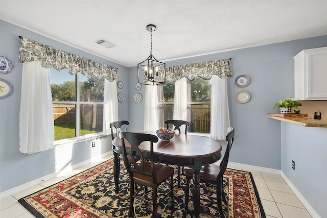 dining area featuring light tile patterned floors and a chandelier