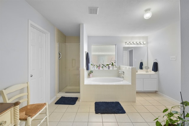 bathroom featuring tile patterned floors, separate shower and tub, and vanity