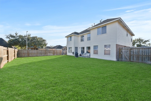 rear view of house with a yard