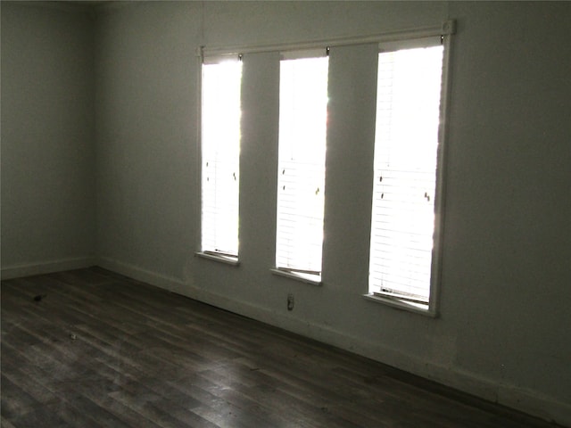 empty room featuring dark hardwood / wood-style flooring