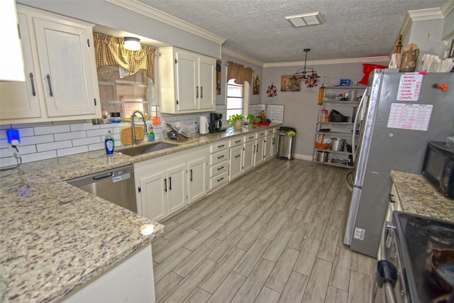 kitchen with light stone countertops, sink, appliances with stainless steel finishes, and light hardwood / wood-style flooring