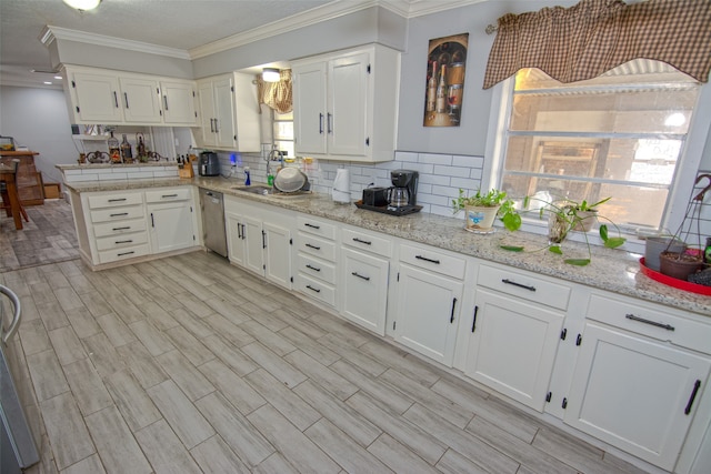 kitchen featuring white cabinets, ornamental molding, and light hardwood / wood-style flooring