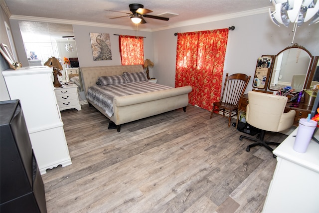 bedroom with ceiling fan, hardwood / wood-style floors, a textured ceiling, and ornamental molding