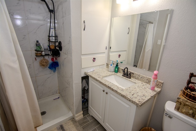 bathroom with vanity, curtained shower, and toilet