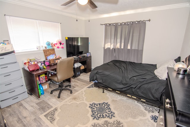 bedroom with crown molding, ceiling fan, and light wood-type flooring