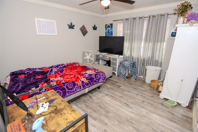 bedroom with hardwood / wood-style flooring, ceiling fan, ornamental molding, and multiple windows