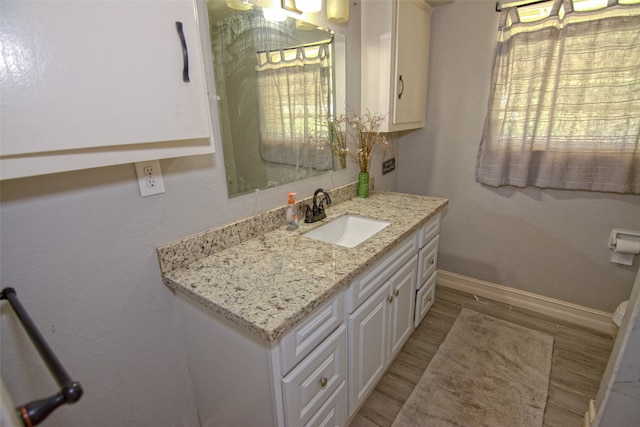 bathroom featuring hardwood / wood-style floors and vanity