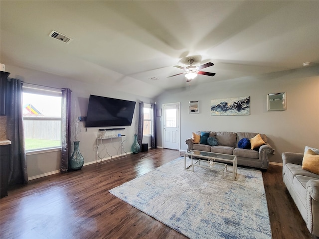 living room featuring a wealth of natural light, ceiling fan, dark hardwood / wood-style floors, and vaulted ceiling