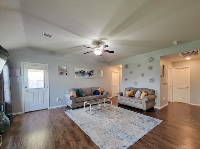 living room featuring dark hardwood / wood-style floors, vaulted ceiling, and ceiling fan