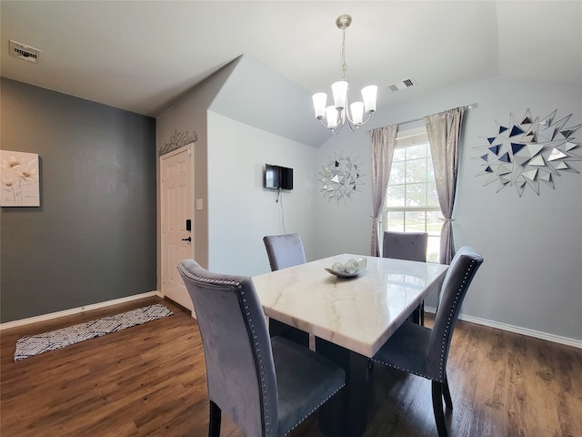 dining area featuring dark hardwood / wood-style floors, lofted ceiling, and a chandelier