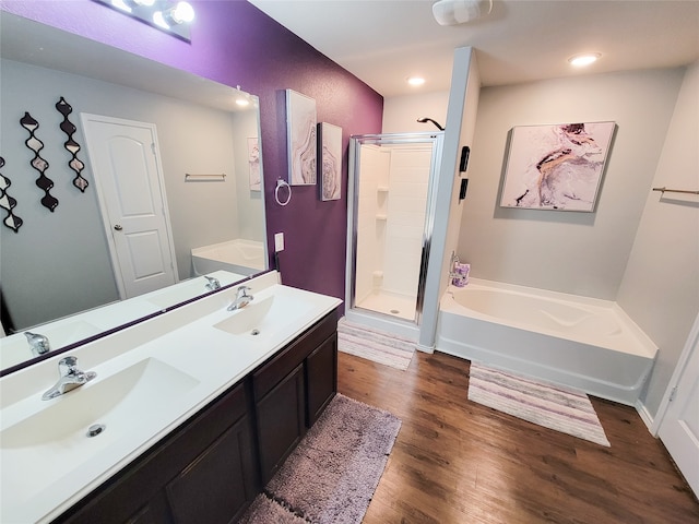 bathroom featuring hardwood / wood-style flooring, vanity, and independent shower and bath