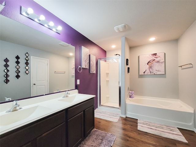 bathroom with vanity, separate shower and tub, and wood-type flooring