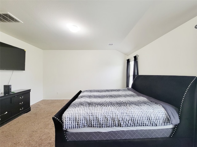 bedroom featuring carpet floors and lofted ceiling