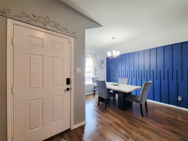 dining room featuring a chandelier and dark wood-type flooring