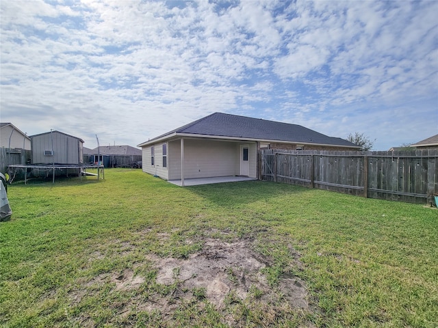 view of yard featuring a trampoline and a patio area