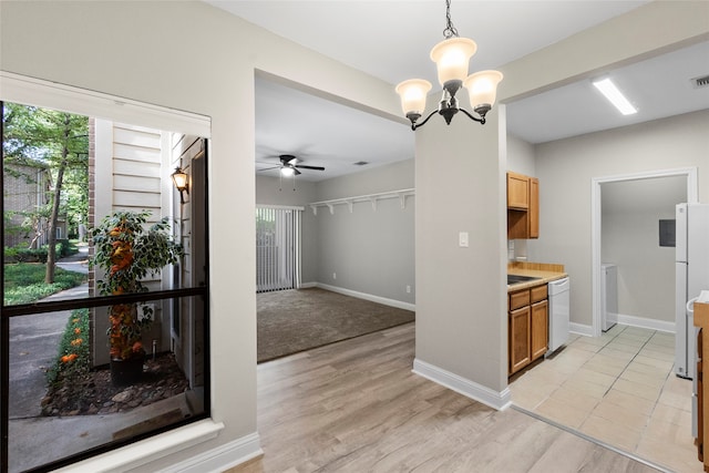 kitchen featuring white appliances, light hardwood / wood-style floors, and a wealth of natural light