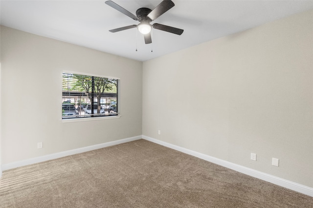 empty room featuring carpet floors and ceiling fan