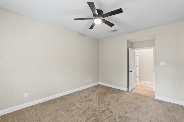 carpeted empty room with ceiling fan