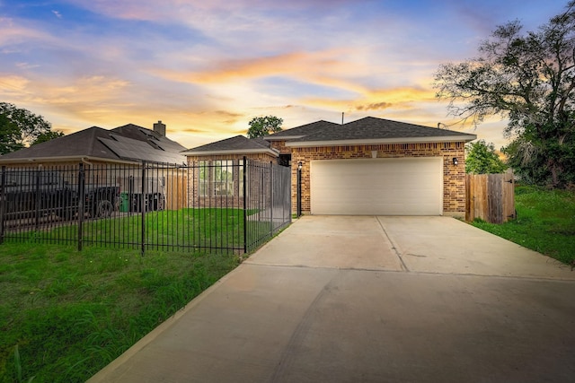 view of front of house featuring a garage and a yard