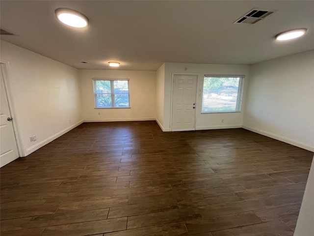 entrance foyer featuring dark hardwood / wood-style flooring and a healthy amount of sunlight