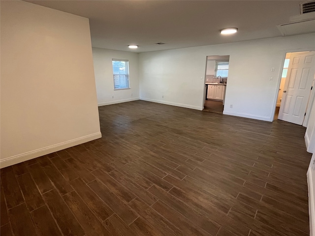 unfurnished room featuring sink and dark hardwood / wood-style floors