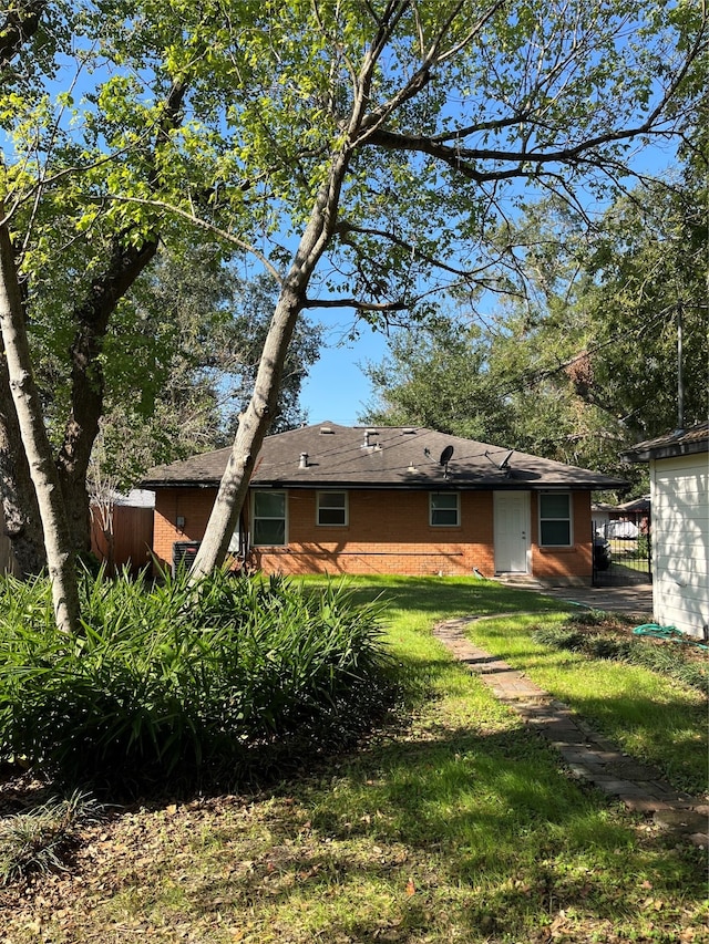 rear view of house with a lawn