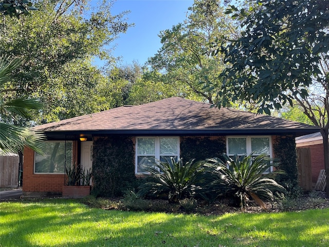 ranch-style home with a front lawn