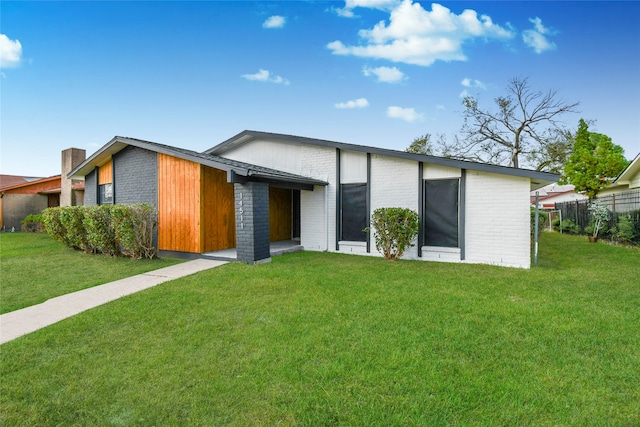 contemporary home with a front lawn