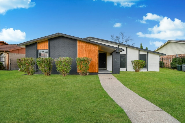 ranch-style house with a front lawn