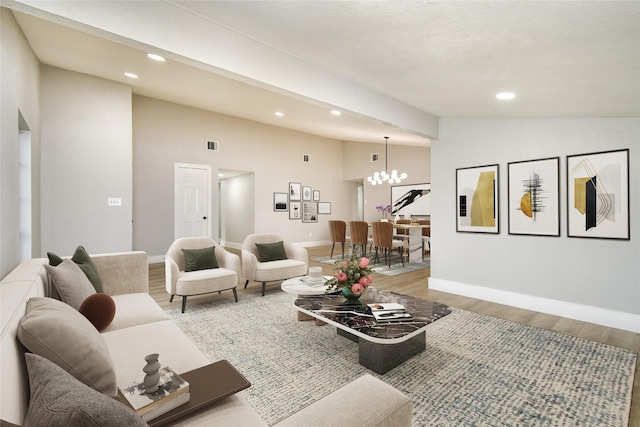 living room featuring light wood-type flooring, a notable chandelier, and lofted ceiling