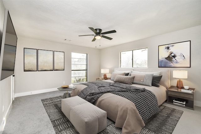 bedroom with multiple windows, ceiling fan, carpet floors, and a textured ceiling