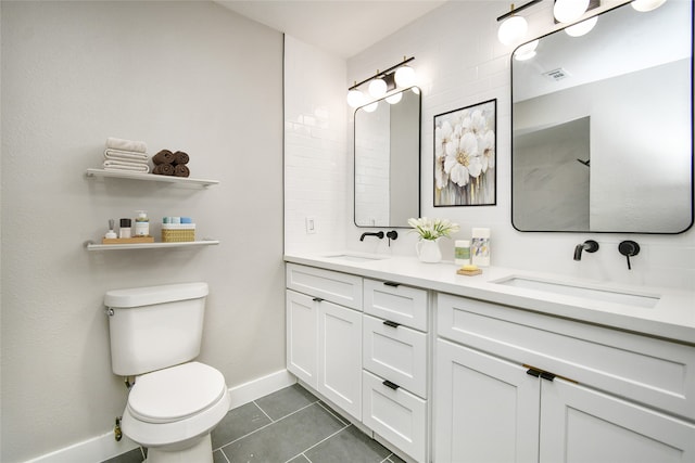 bathroom with tile patterned flooring, decorative backsplash, vanity, and toilet