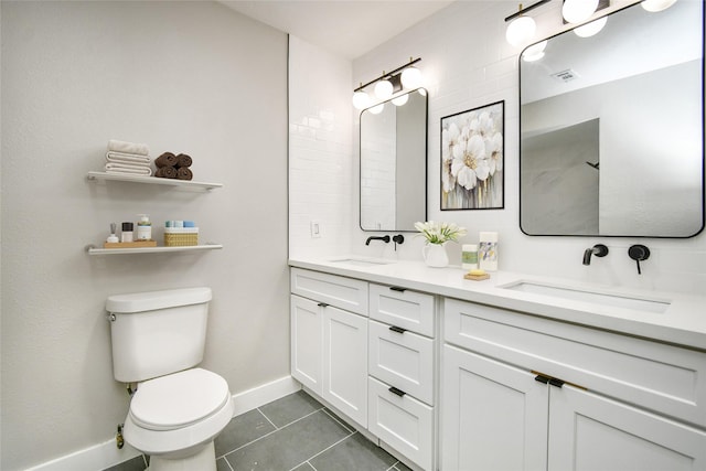 bathroom with toilet, tile patterned flooring, and vanity