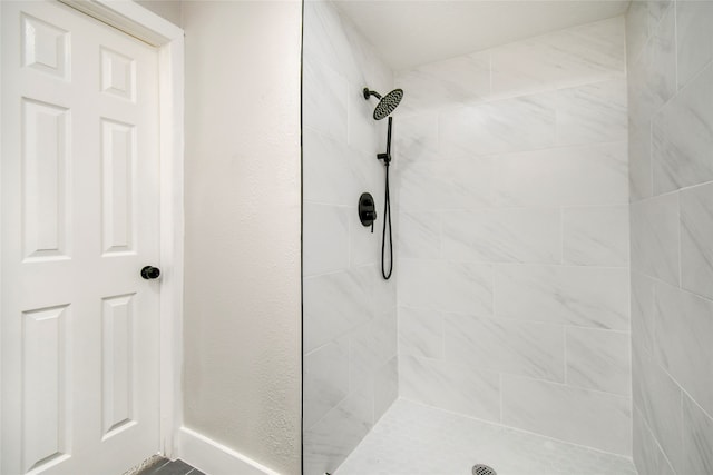 bathroom with a tile shower