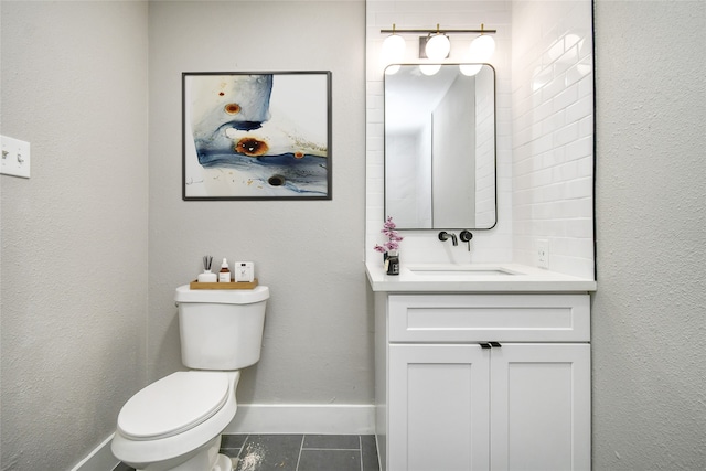 bathroom featuring tile patterned flooring, vanity, and toilet