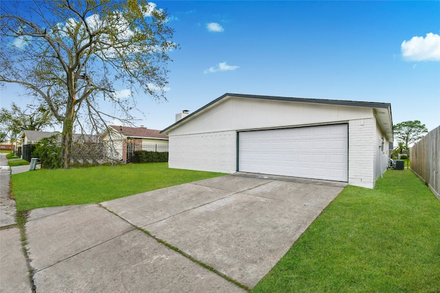 garage with a lawn and central AC unit