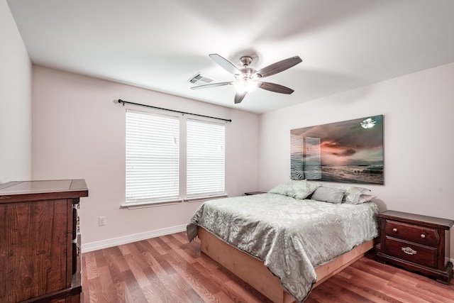 bedroom with hardwood / wood-style floors and ceiling fan