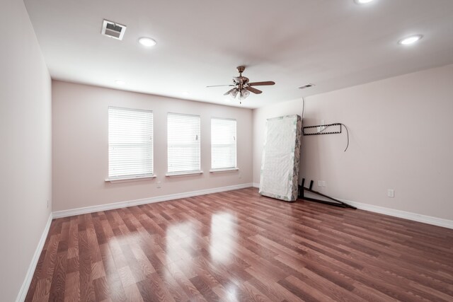 empty room featuring ceiling fan and hardwood / wood-style floors