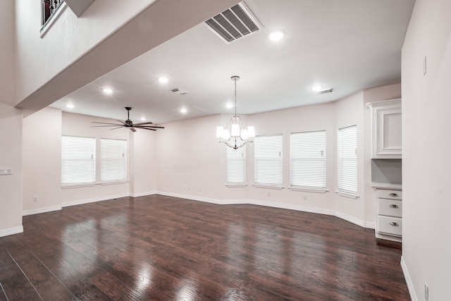 unfurnished living room with dark hardwood / wood-style floors and ceiling fan with notable chandelier