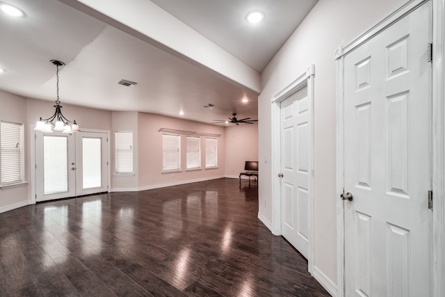 interior space with ceiling fan with notable chandelier, dark wood-type flooring, and french doors