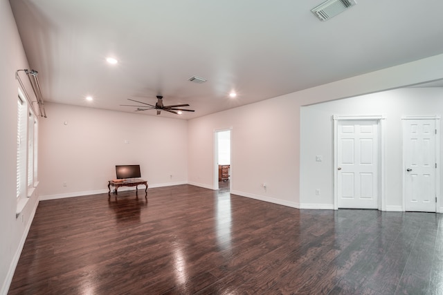 interior space featuring dark wood-type flooring and ceiling fan