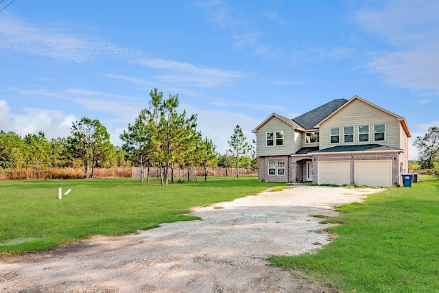 view of front of property featuring a garage and a front lawn